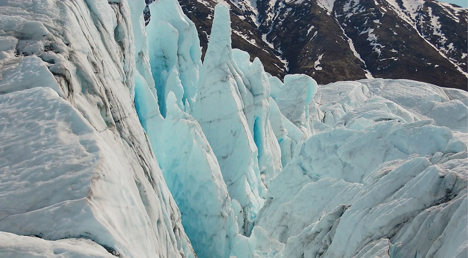 Blue ice spires and seracs rising along the flank of the Matanuska Glacier