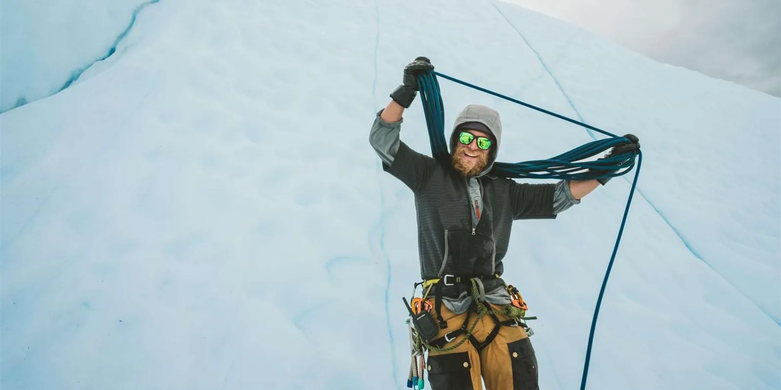 Guide coiling ropes at the top of the ice-climbing wall