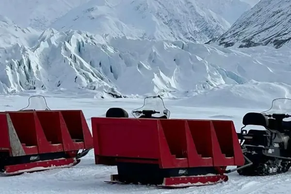 Passenger sleds hitched to a snow machine at the Matanuska Glacier in winter